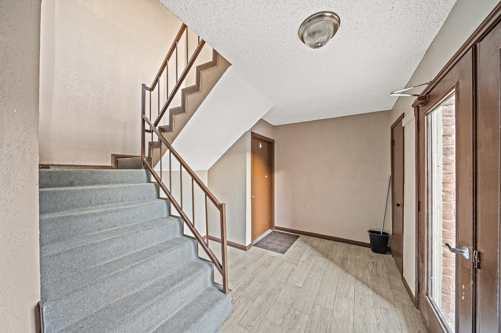 12100 Overbrook Lane, Unit 17D Houston, TX 77077 - Photo 4 of 22 a view of entryway and hall with wooden floor