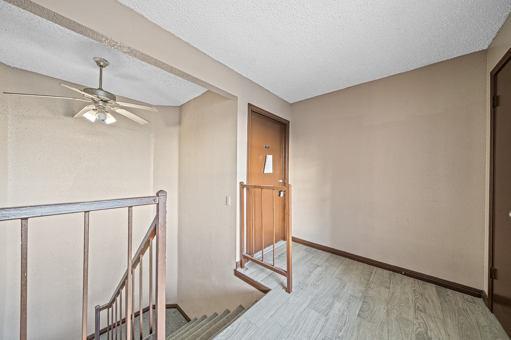 12100 Overbrook Lane, Unit 17D Houston, TX 77077 - Photo 5 of 22 a view of an empty room with wooden floor