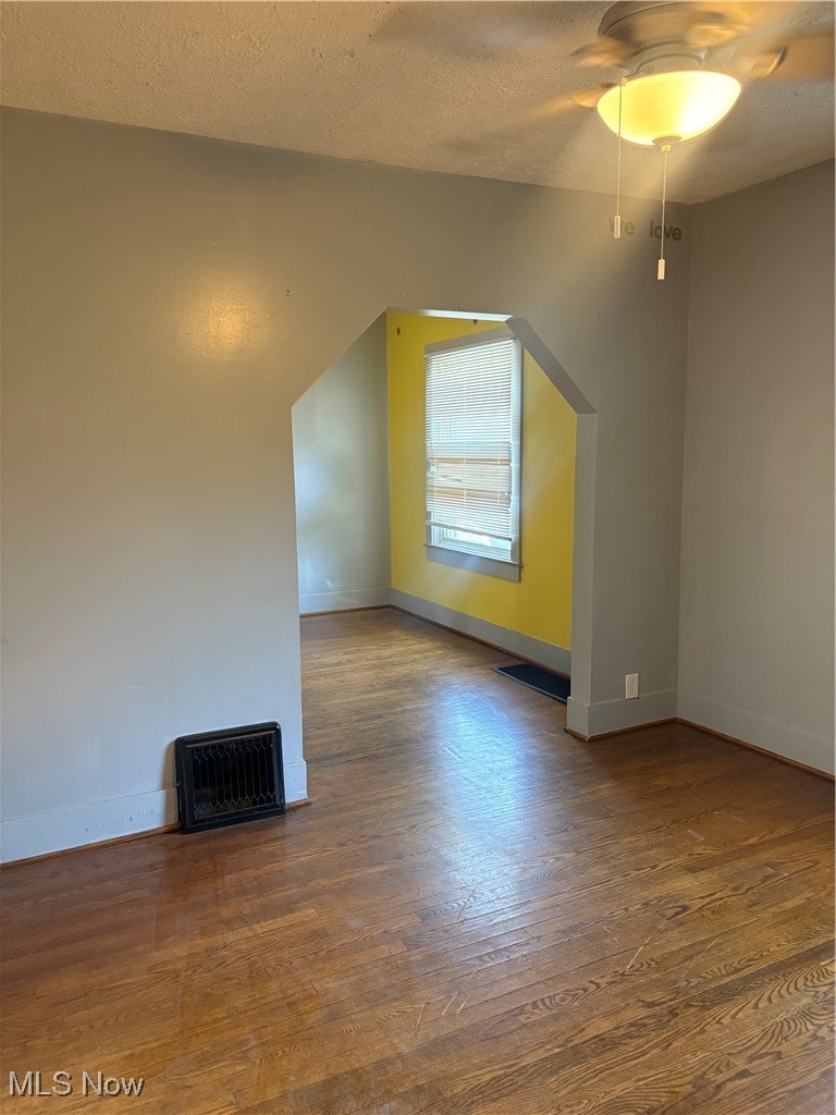 11 Front Street Rittman, OH 44270 - Photo 2 of 31 Additional living space with wood finished floors, a ceiling fan, and a textured ceiling
