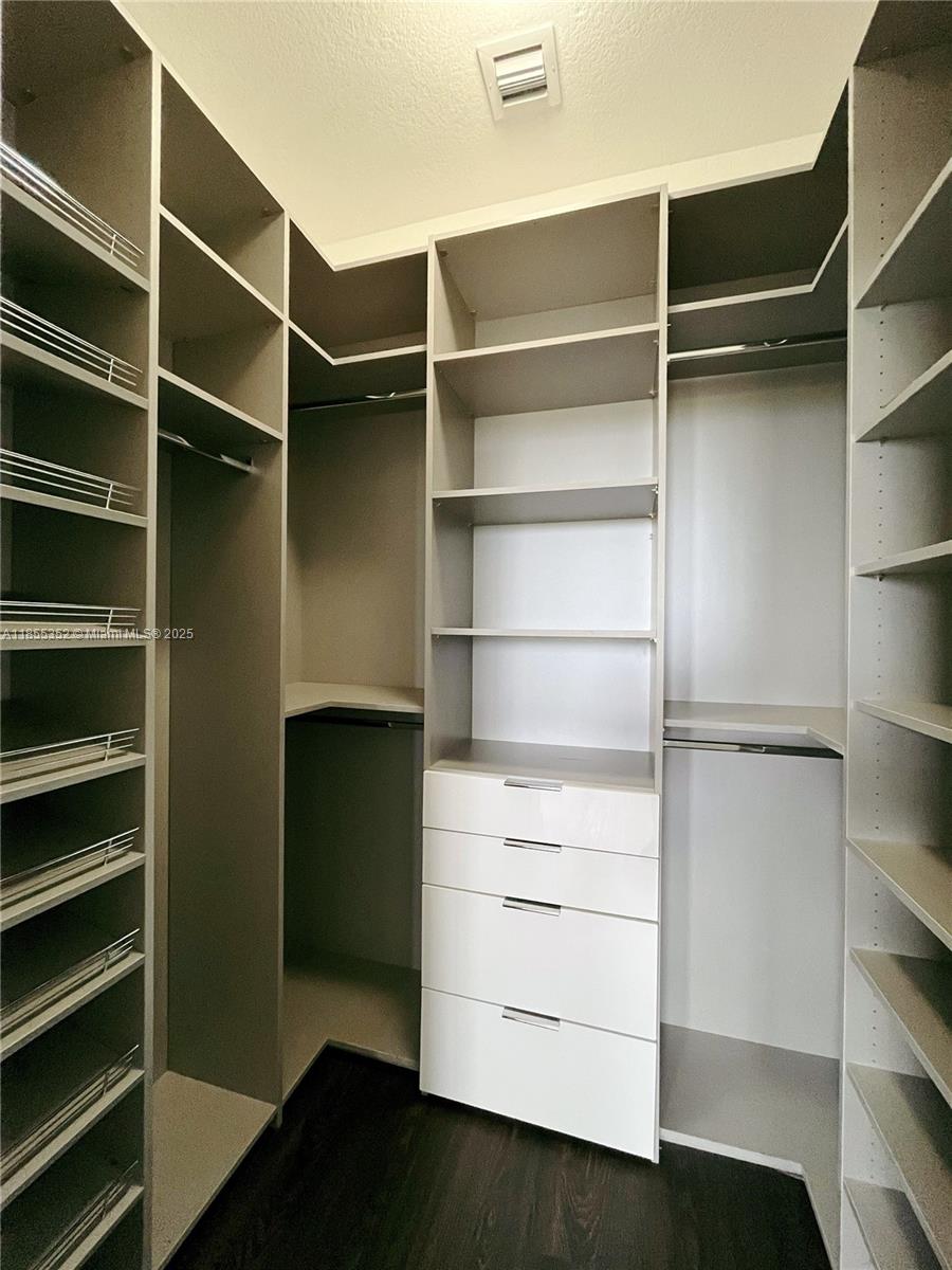 15650 Southwest 136th Street, Unit 218 Miami, FL 33196 - Photo 12 of 25 a view of walk in closet with empty racks