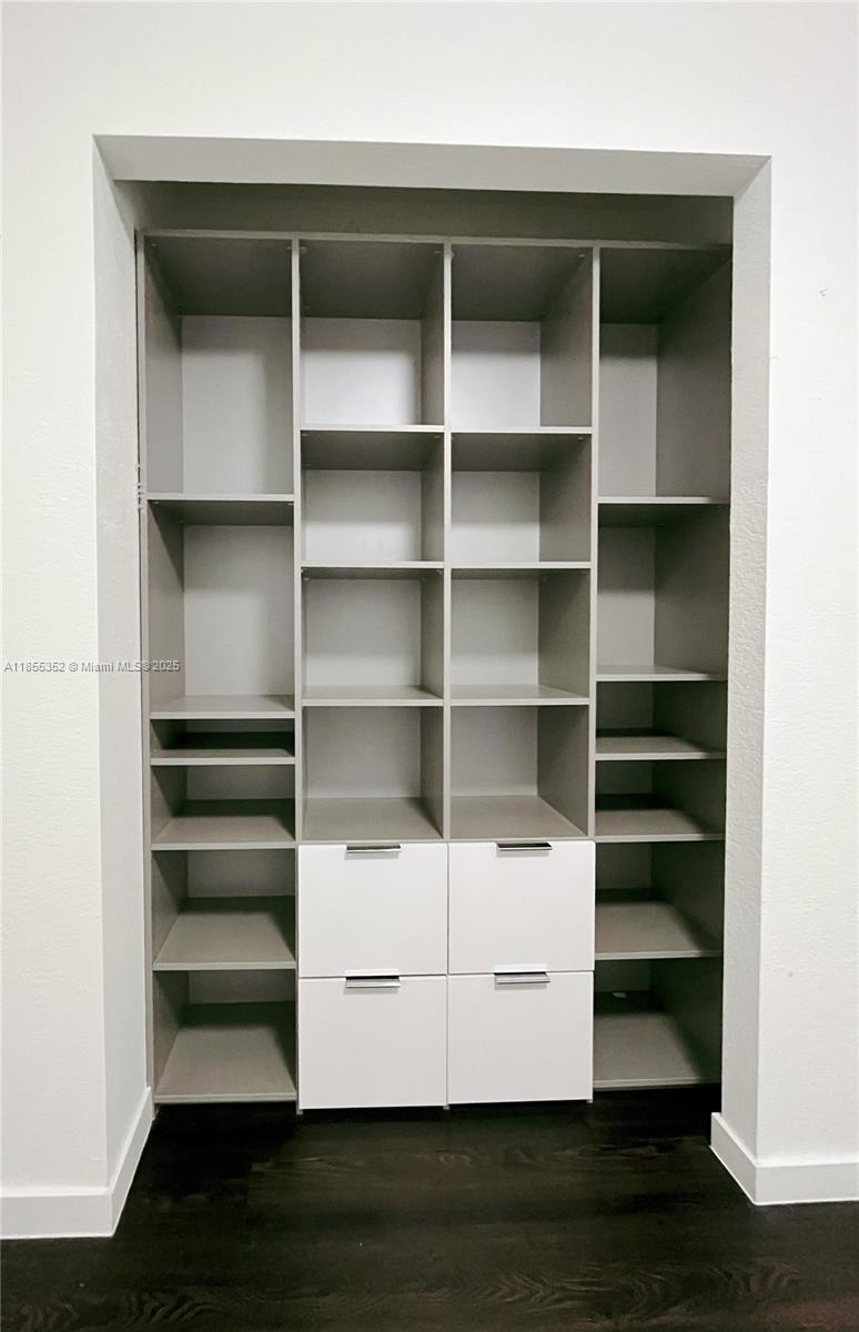 15650 Southwest 136th Street, Unit 218 Miami, FL 33196 - Photo 15 of 25 a view of walk in closet with empty racks