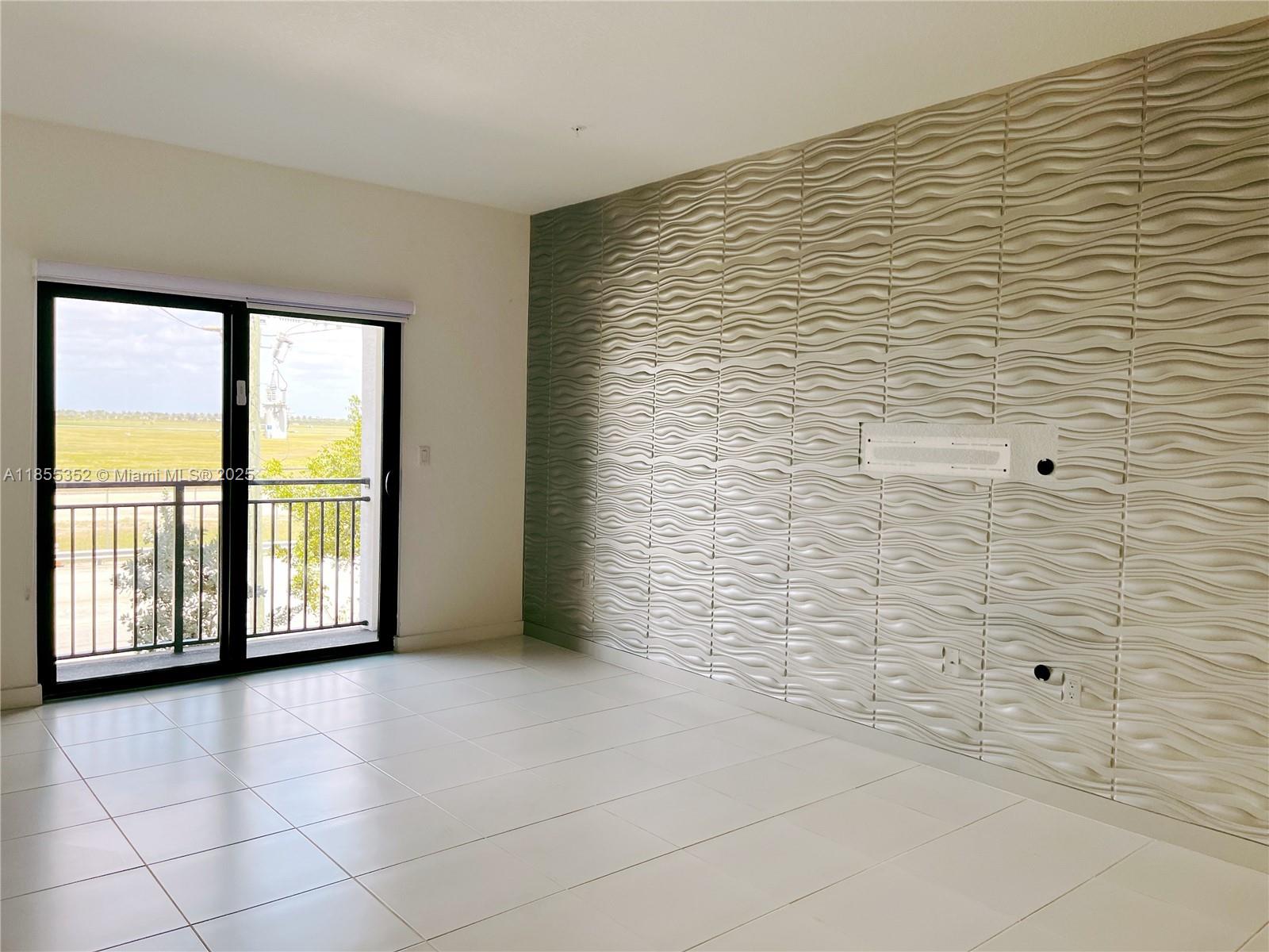 15650 Southwest 136th Street, Unit 218 Miami, FL 33196 - Photo 18 of 25 a view of an empty room with a window