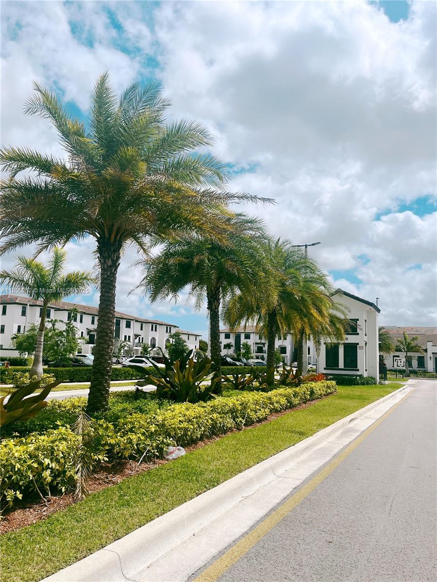 15650 Southwest 136th Street, Unit 218 Miami, FL 33196 - Photo 21 of 25 a front view of a house with a yard