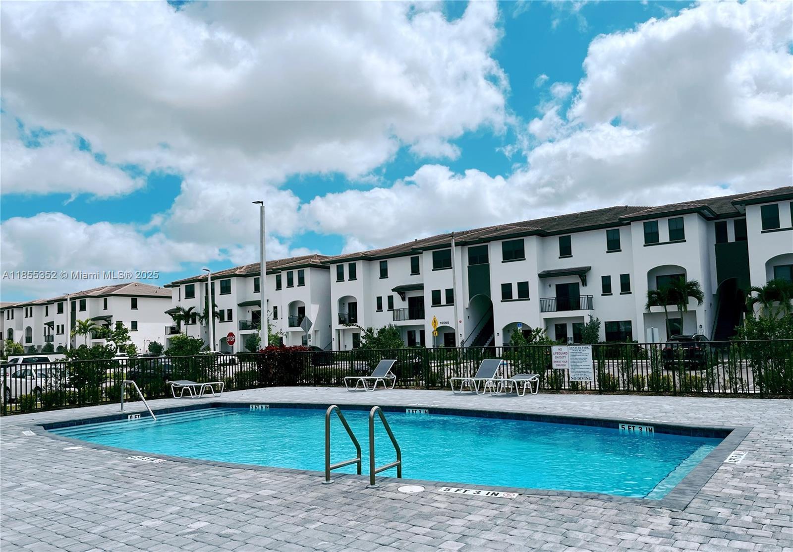 15650 Southwest 136th Street, Unit 218 Miami, FL 33196 - Photo 23 of 25 a view of swimming pool with outdoor seating and plants