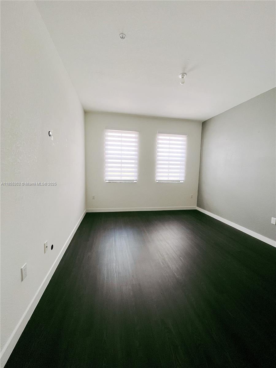 15650 Southwest 136th Street, Unit 218 Miami, FL 33196 - Photo 9 of 25 an empty room with a window