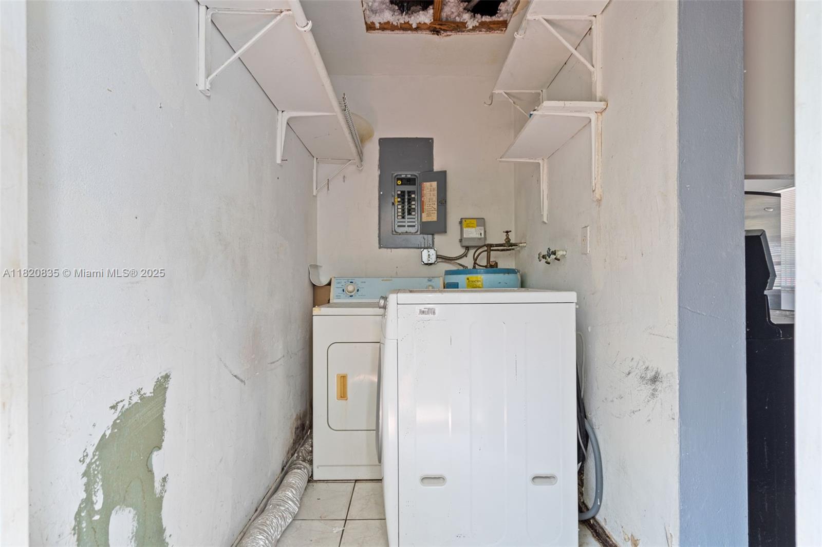 2920 Southwest 37th Court Miami, FL 33134 - Photo 11 of 48 a utility room with cabinets washer and dryer