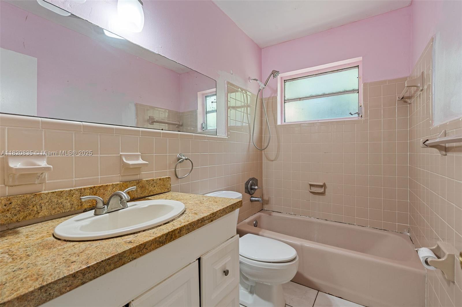 2920 Southwest 37th Court Miami, FL 33134 - Photo 14 of 48 a bathroom with a sink a toilet a mirror and bathtub