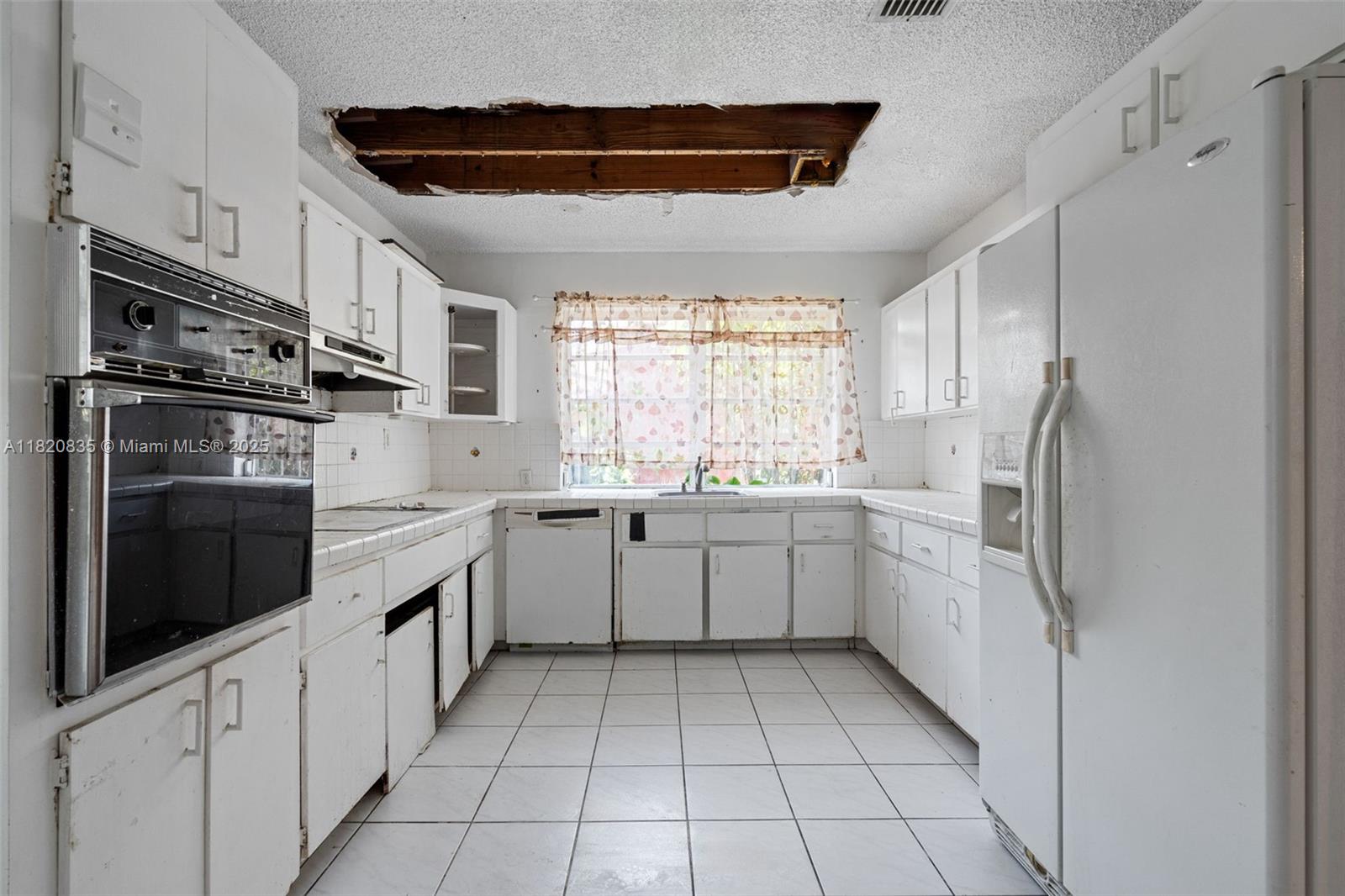 2920 Southwest 37th Court Miami, FL 33134 - Photo 25 of 48 a kitchen with a sink window and stainless steel appliances