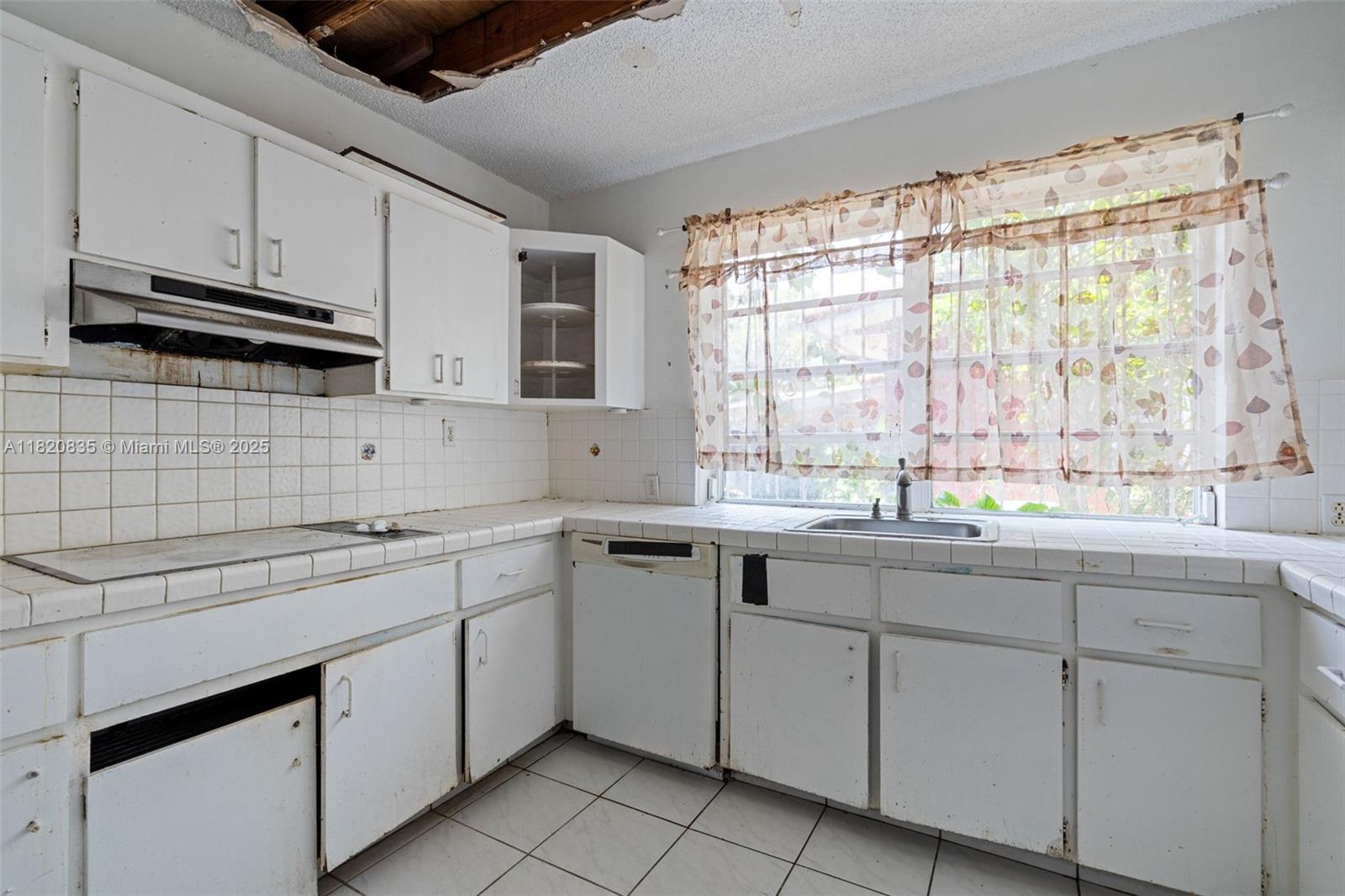 2920 Southwest 37th Court Miami, FL 33134 - Photo 26 of 48 a kitchen with sink cabinets and appliances