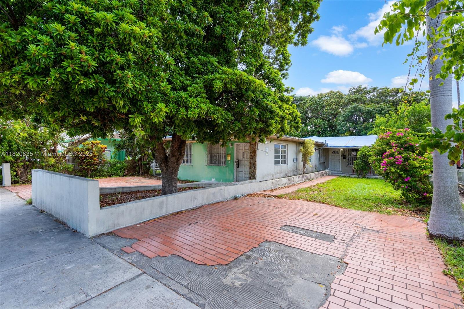 2920 Southwest 37th Court Miami, FL 33134 - Photo 3 of 48 a view of a house with a yard and a large tree