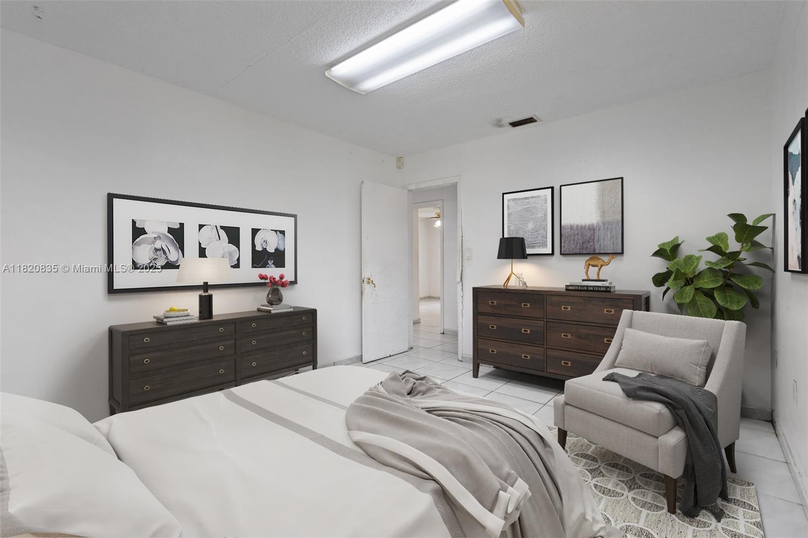 2920 Southwest 37th Court Miami, FL 33134 - Photo 31 of 48 a bedroom with a bed painting on wall and a potted plant