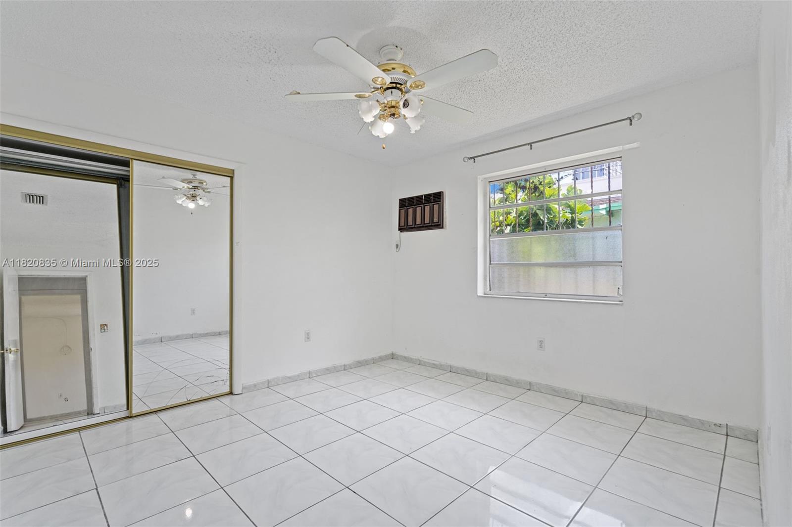 2920 Southwest 37th Court Miami, FL 33134 - Photo 33 of 48 an empty room with windows and ceiling fan