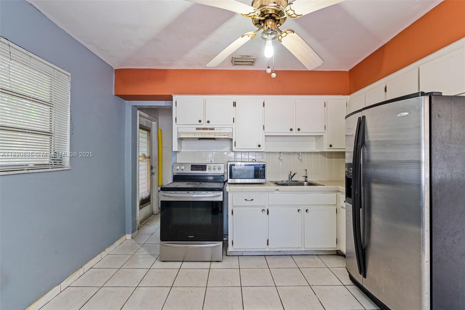 2920 Southwest 37th Court Miami, FL 33134 - Photo 9 of 48 a kitchen with stainless steel appliances a stove a refrigerator a sink and white cabinets