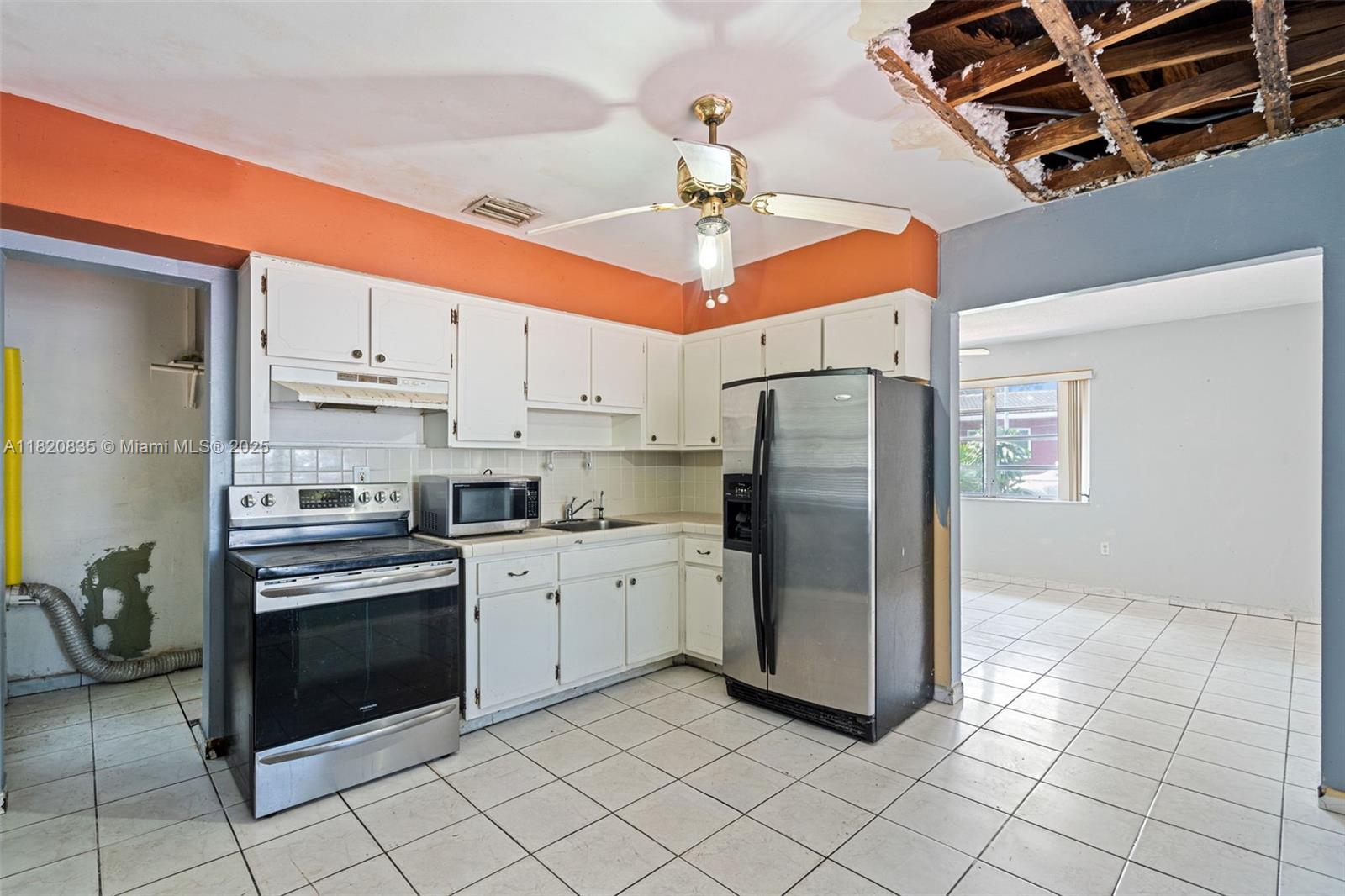2920 Southwest 37th Court Miami, FL 33134 - Photo 10 of 48 a kitchen with stainless steel appliances granite countertop a refrigerator a stove and a sink