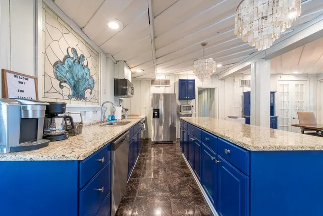 a bedroom with a large bed a flat tv screen and a window