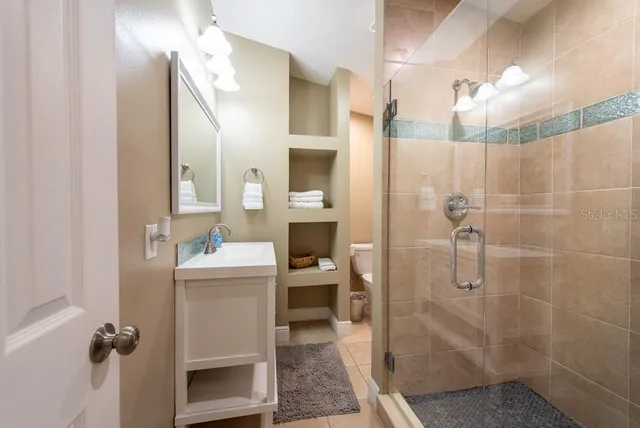 a spacious bedroom with a bed and a chandelier