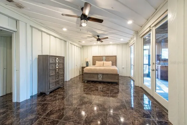 a view of a dining room with furniture and a chandelier