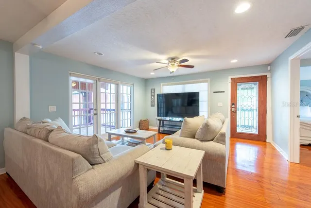 a view of a house with a backyard and a tree