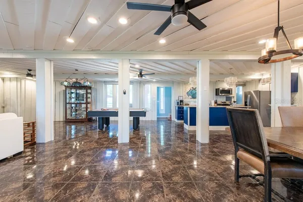 a large kitchen with stainless steel appliances kitchen island granite countertop a refrigerator a stove a sink and dishwasher