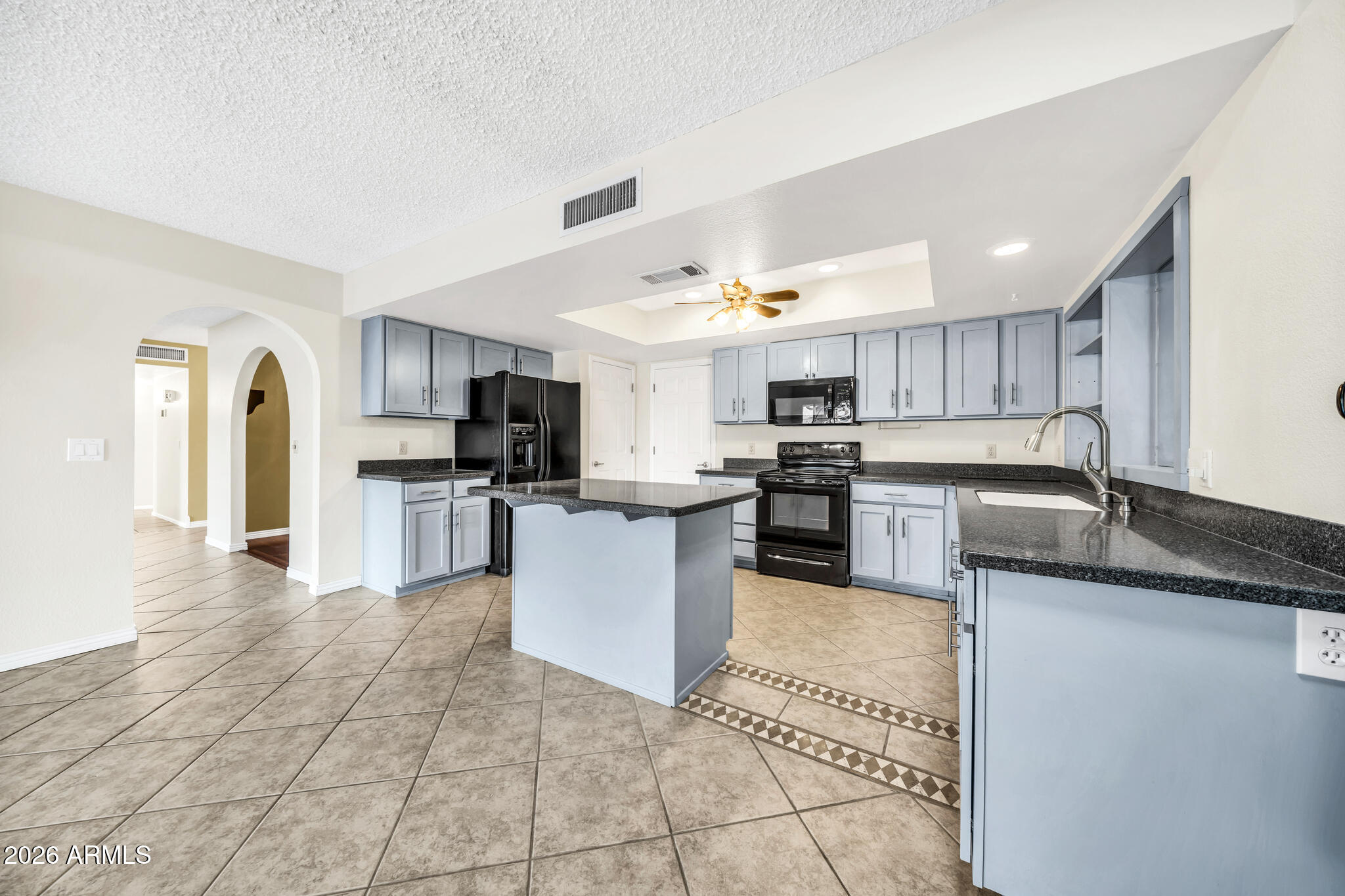 3033 West Kathleen Road Phoenix, AZ 85053 - Photo 11 of 42 a large kitchen with granite countertop a large counter top stainless steel appliances and cabinets