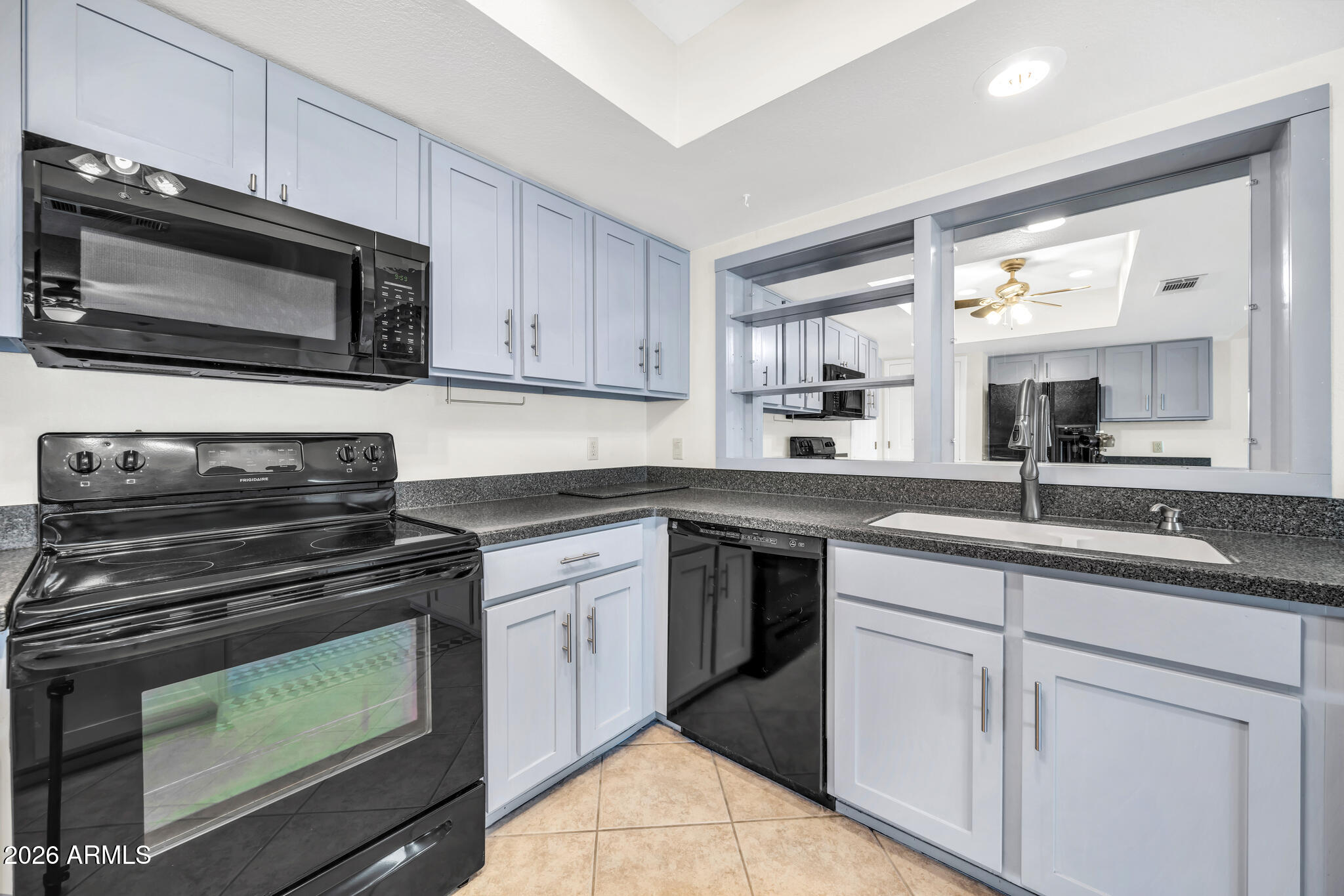 3033 West Kathleen Road Phoenix, AZ 85053 - Photo 14 of 42 a kitchen with cabinets stainless steel appliances and a sink
