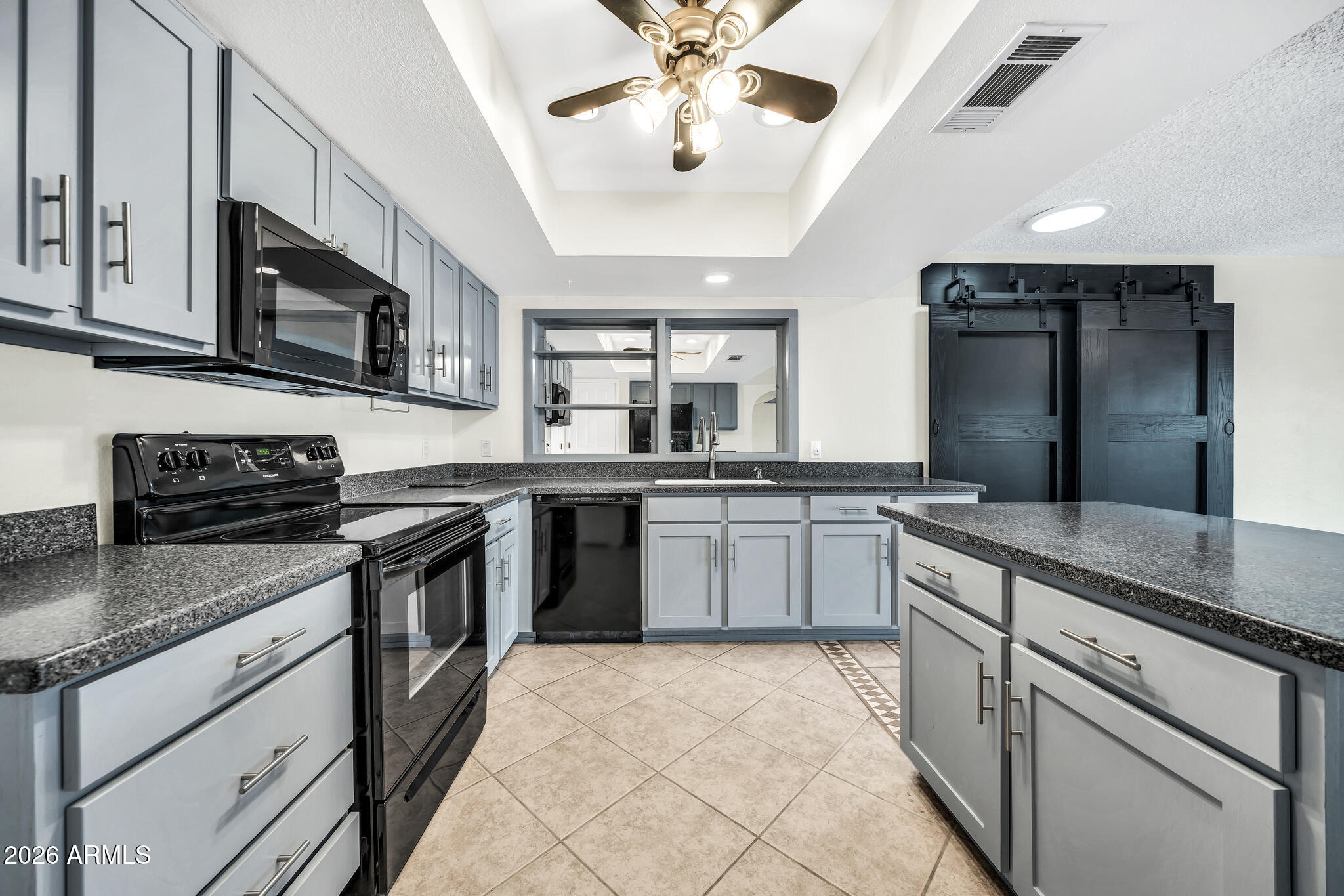 3033 West Kathleen Road Phoenix, AZ 85053 - Photo 15 of 42 a kitchen with stainless steel appliances granite countertop a sink and stove top oven
