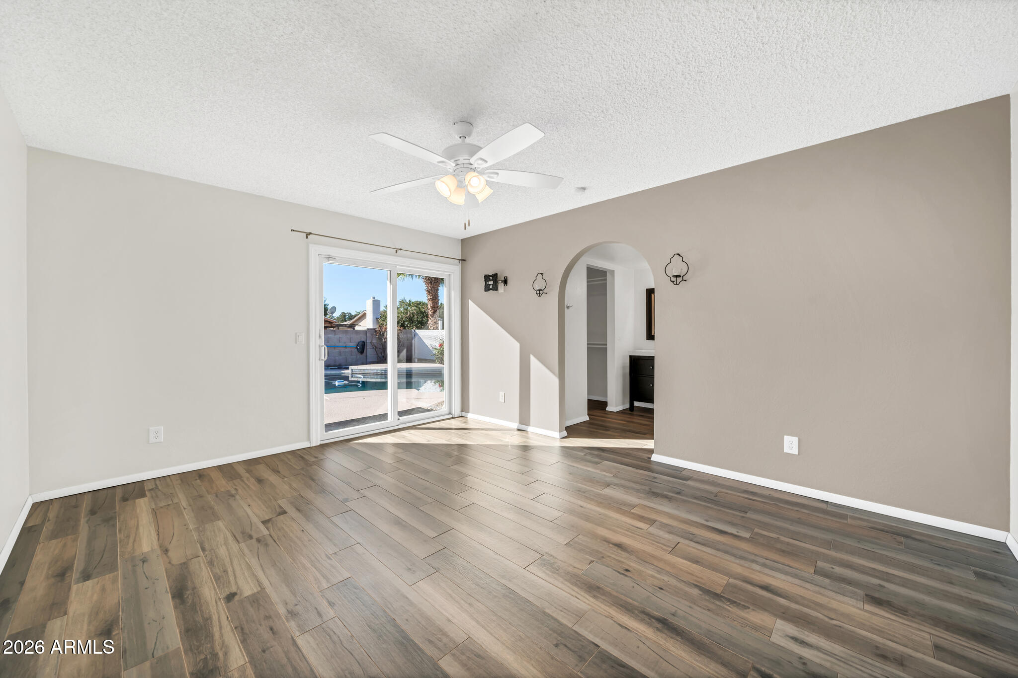 3033 West Kathleen Road Phoenix, AZ 85053 - Photo 18 of 42 wooden floor in an empty room with a window