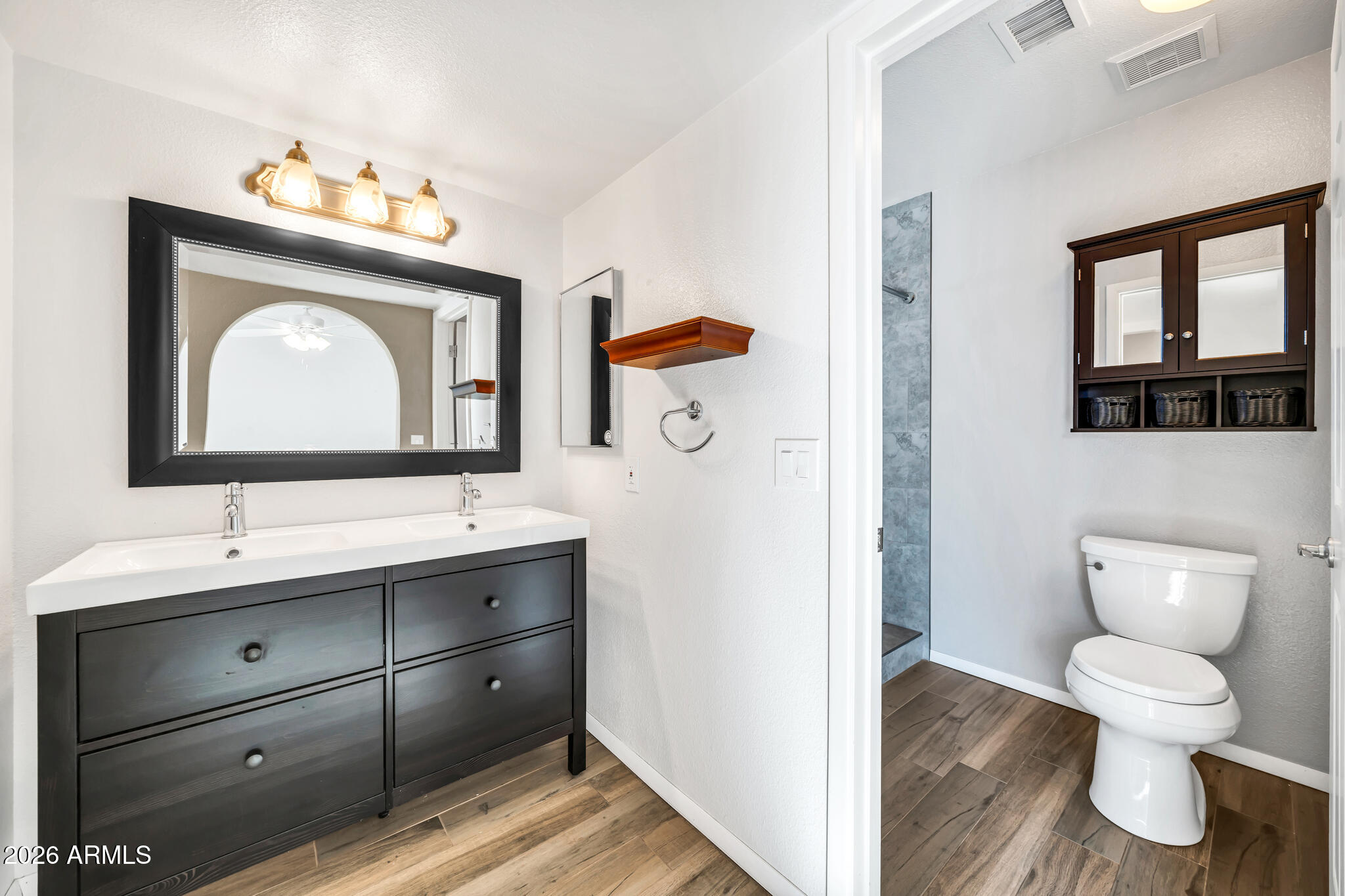 3033 West Kathleen Road Phoenix, AZ 85053 - Photo 19 of 42 a bathroom with a toilet sink and mirror