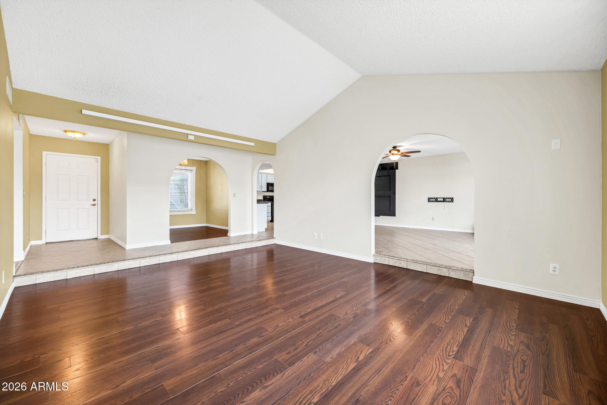 3033 West Kathleen Road Phoenix, AZ 85053 - Photo 8 of 42 a view of empty room with wooden floor and fan