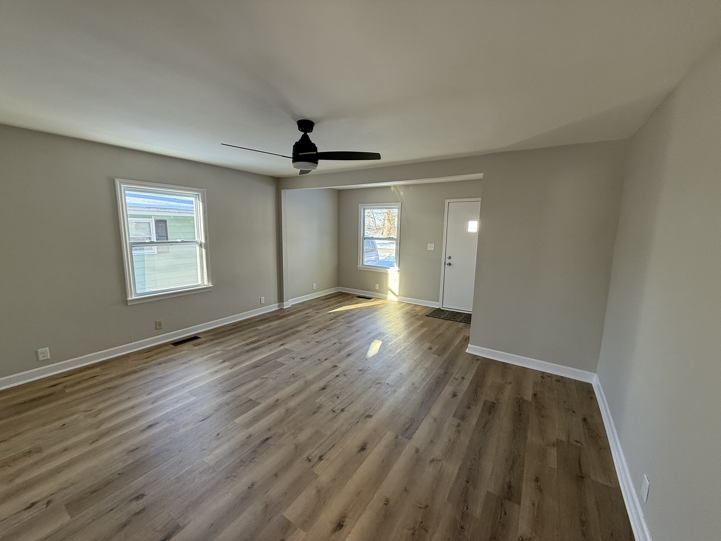 418 East Chestnut Street Paxton, IL 60957 - Photo 3 of 16 a view of empty room with wooden floor and fan