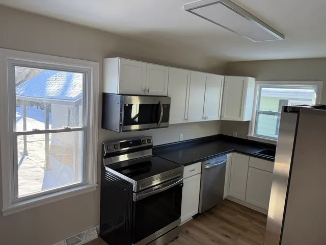 a kitchen with a sink stove and microwave