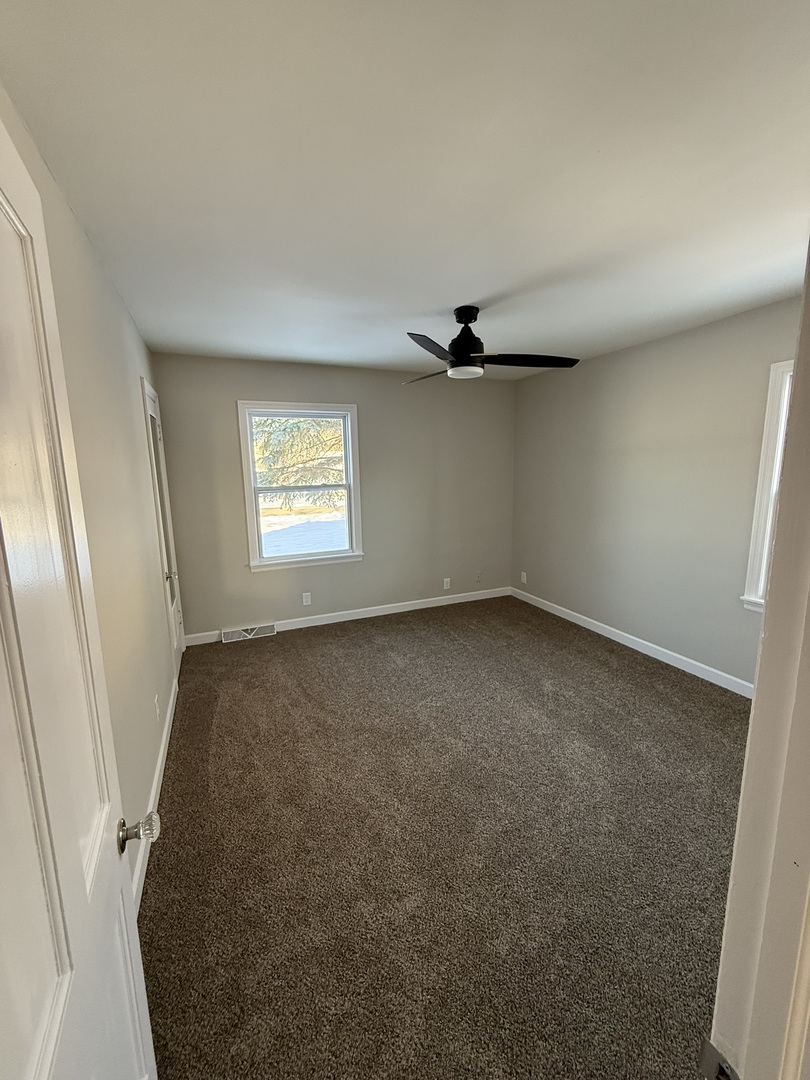 418 East Chestnut Street Paxton, IL 60957 - Photo 7 of 16 an empty room with windows