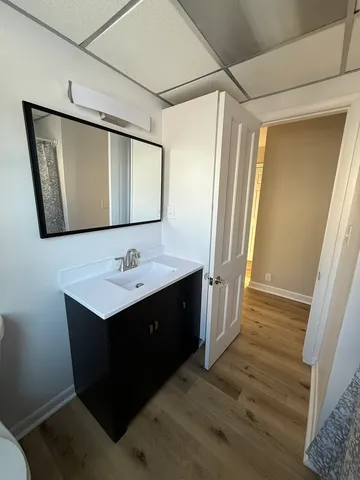 a bathroom with a double vanity sink and mirror