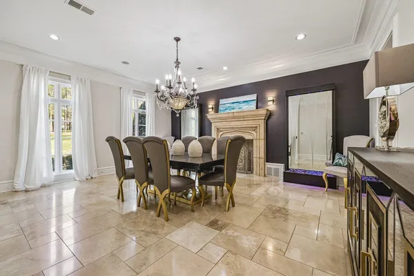 a view of a dining room with furniture and chandelier