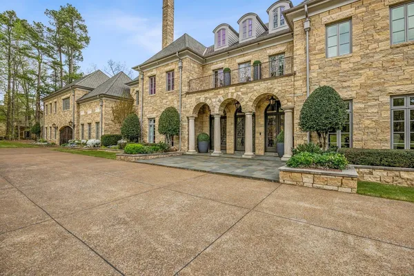 front view of a brick house with a yard