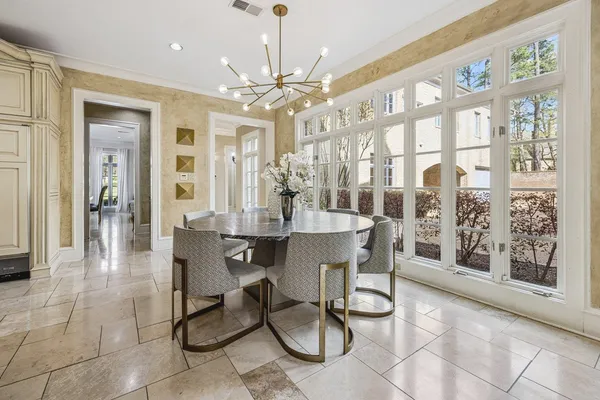 a view of a dining room with furniture wooden floor and chandelier