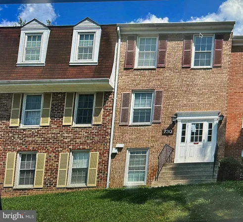 a view of a brick building next to a yard