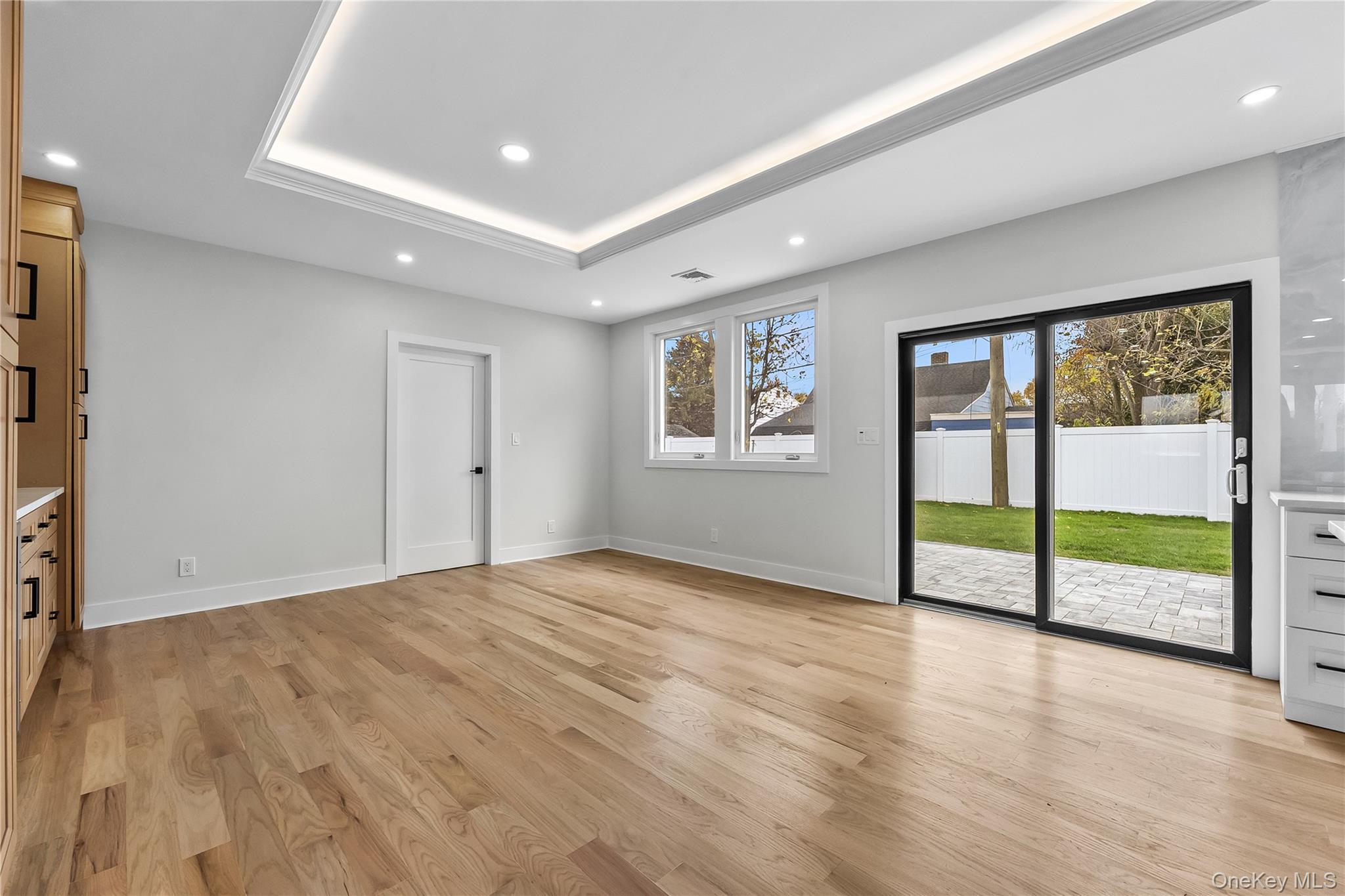 2 Orchid Road Levittown, NY 11756 - Photo 12 of 46 a view of an empty room with a window and wooden floor