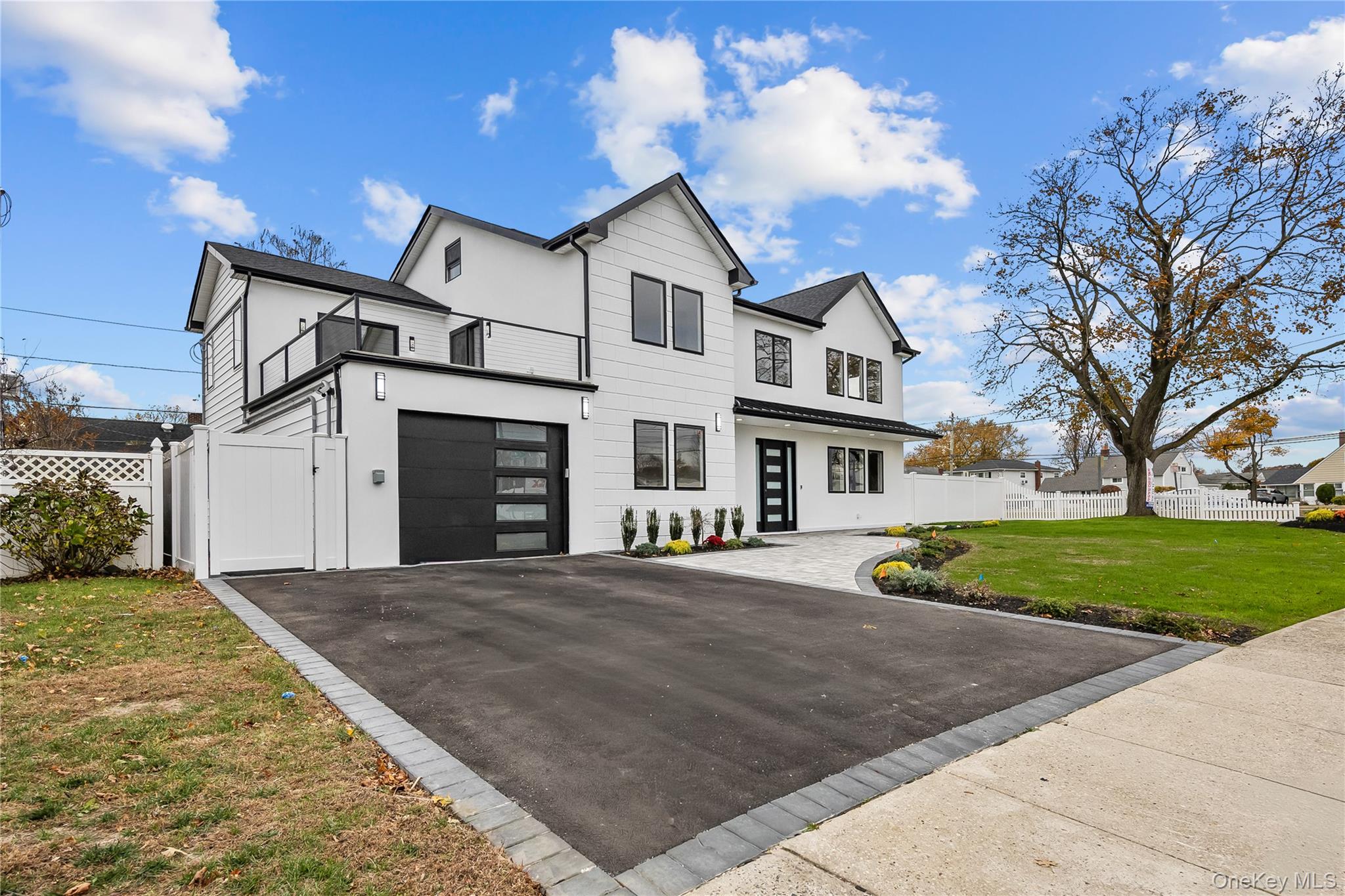 2 Orchid Road Levittown, NY 11756 - Photo 2 of 46 a front view of a house with a yard and garage