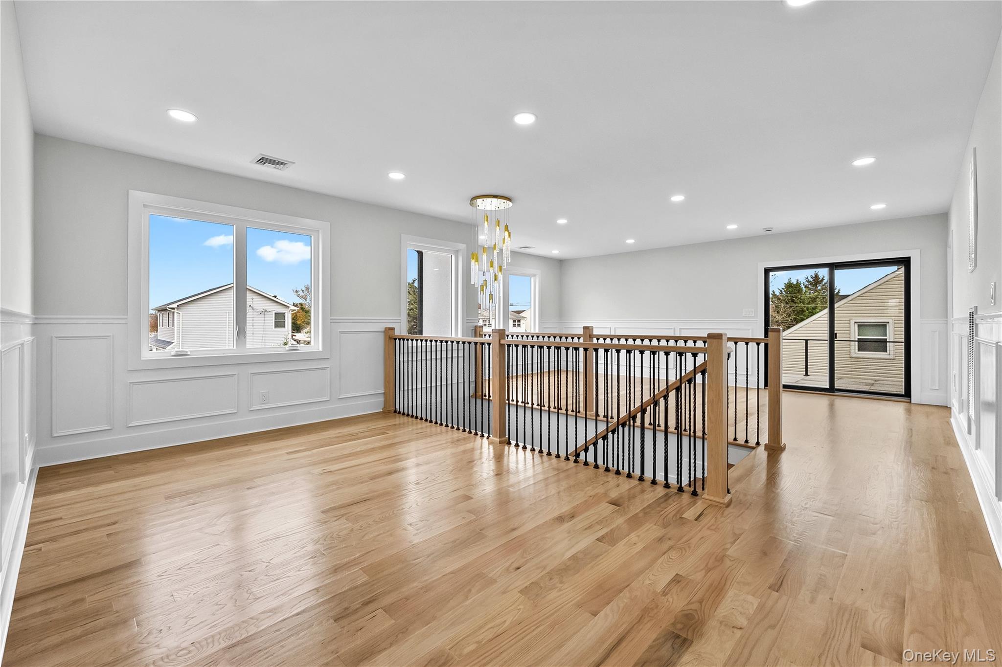 2 Orchid Road Levittown, NY 11756 - Photo 22 of 46 a view of a hallway with wooden floor and windows