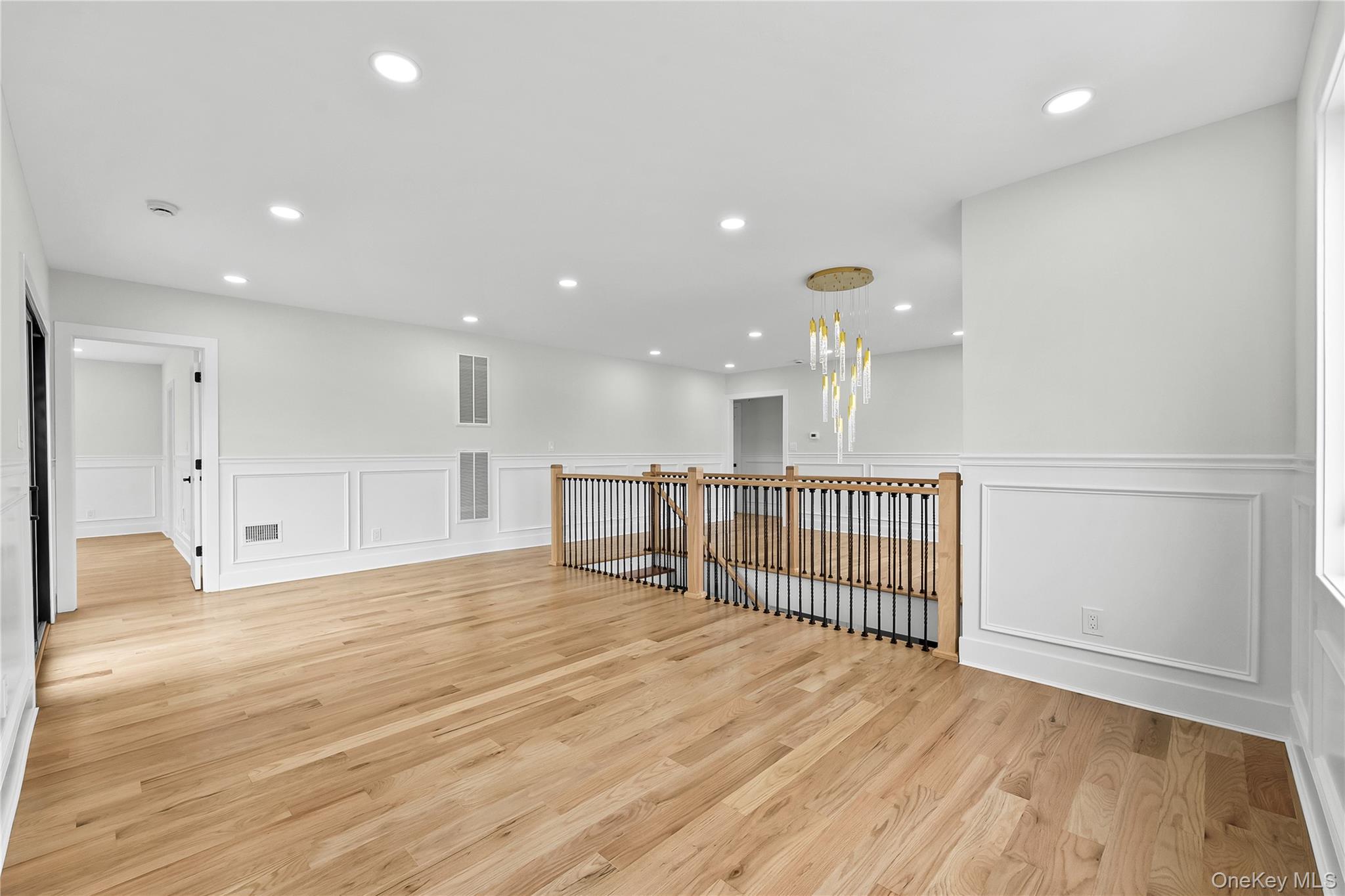 2 Orchid Road Levittown, NY 11756 - Photo 24 of 46 a view of empty room with wooden floor