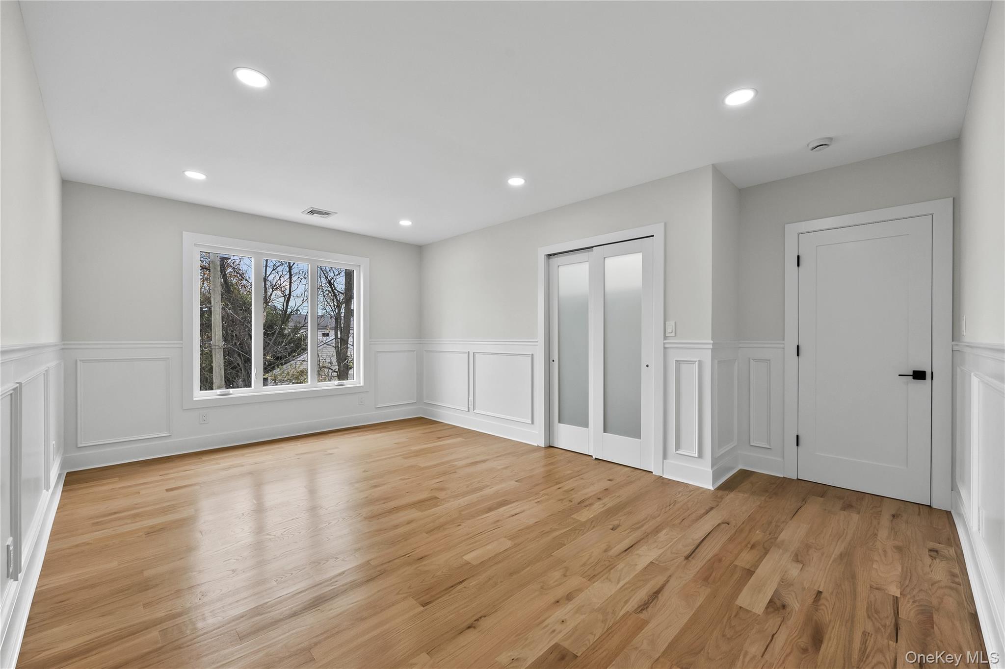 2 Orchid Road Levittown, NY 11756 - Photo 35 of 46 a view of an empty room with wooden floor and a window