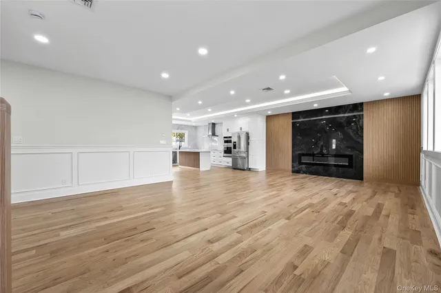 a view of empty room with wooden floor