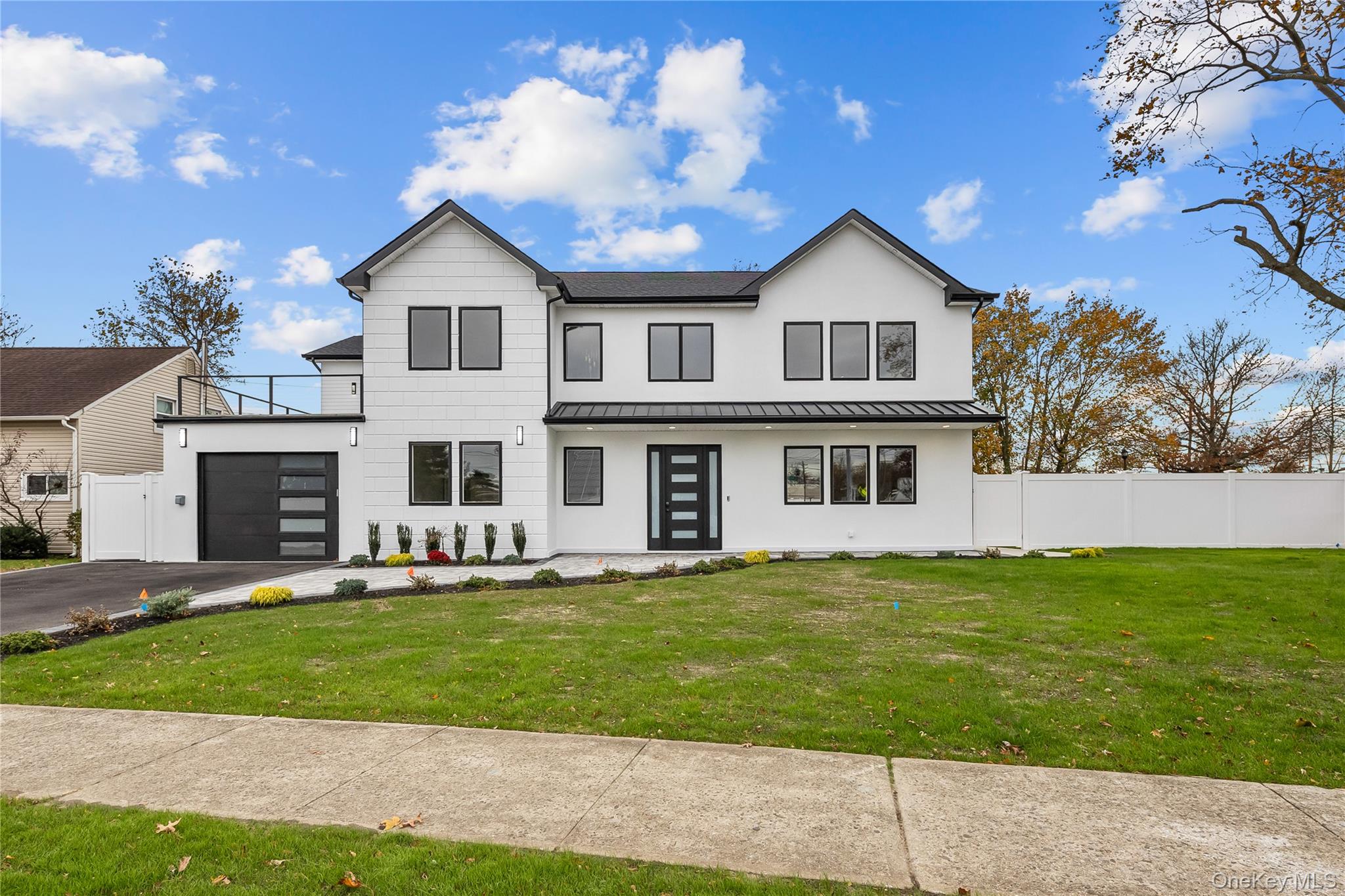 2 Orchid Road Levittown, NY 11756 - Photo 41 of 46 a front view of a house with a garden and yard