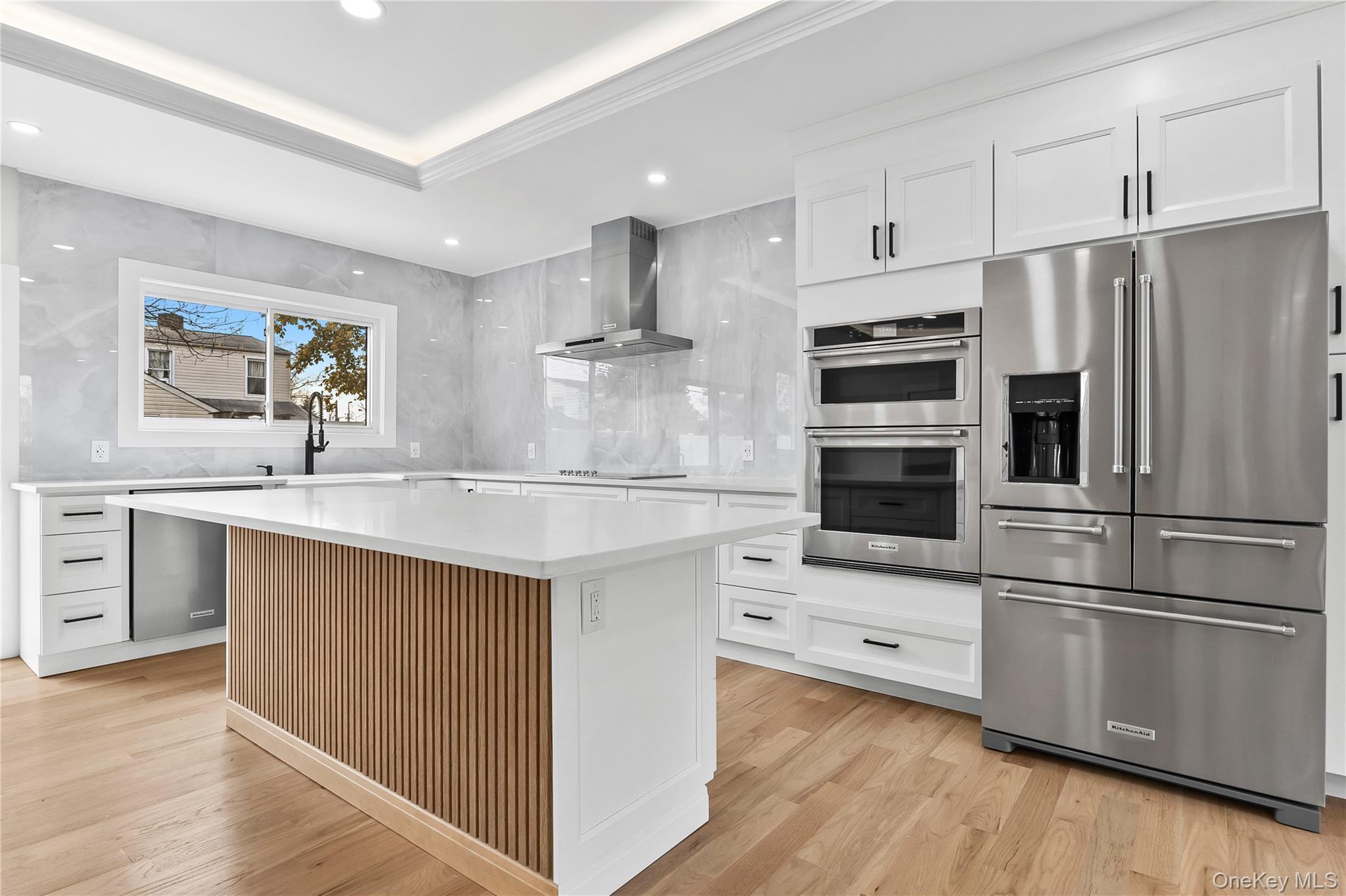 2 Orchid Road Levittown, NY 11756 - Photo 8 of 46 a kitchen with kitchen island a sink stainless steel appliances and cabinets