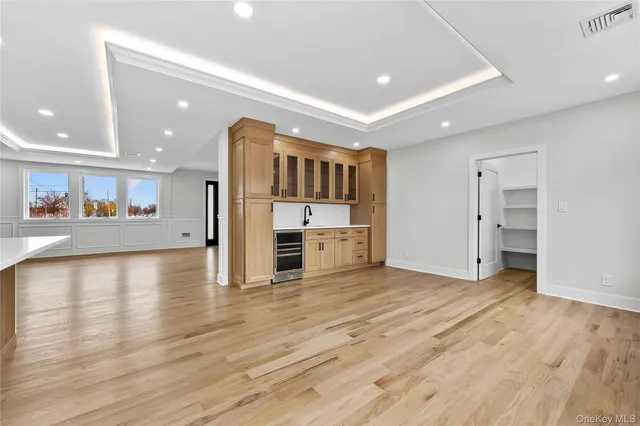a view of a kitchen with stainless steel appliances a refrigerator and a stove top oven