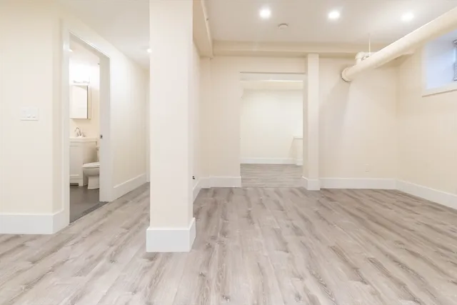 a view of empty room with wooden floor