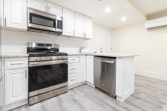 a kitchen with stainless steel appliances granite countertop a stove top oven and sink