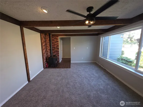 a view of an empty room with a fireplace