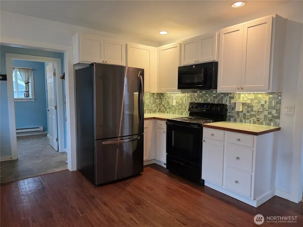 a bathroom with a sink and two mirror